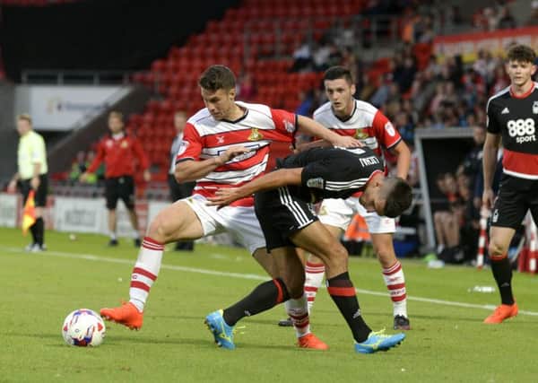 Doncaster Rovers Tommy Rowe attempts to break clear of the attention of Nottingham Forests Eric Lichaj (Picture: Bruce Rollinson).
