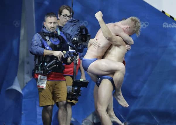 Jack Laugher and Chris Mears embrace afterwinning diving gold at the Olympics.