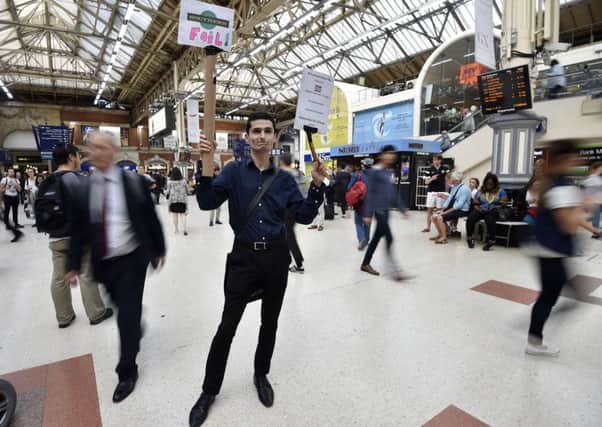Southern Rail passenger Dominic Martin joins a rail strike protest at London Victoria Station against the Southern Rail network, calling for a fare freeze and compensation.