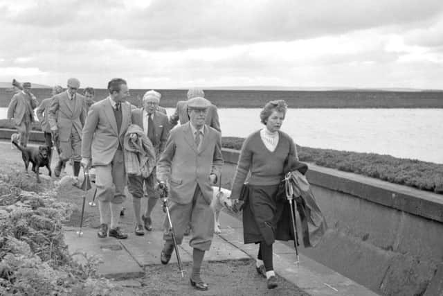 Harold Macmillan walking with the Duchess of Devonshire to the butts at Barden High Moor, Yorkshire