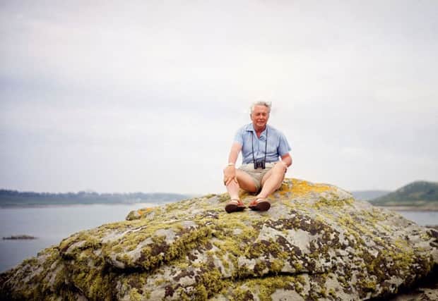 Harold Wilson sitting on a rock during his summer holiday in the Isles of Scilly, in 1965