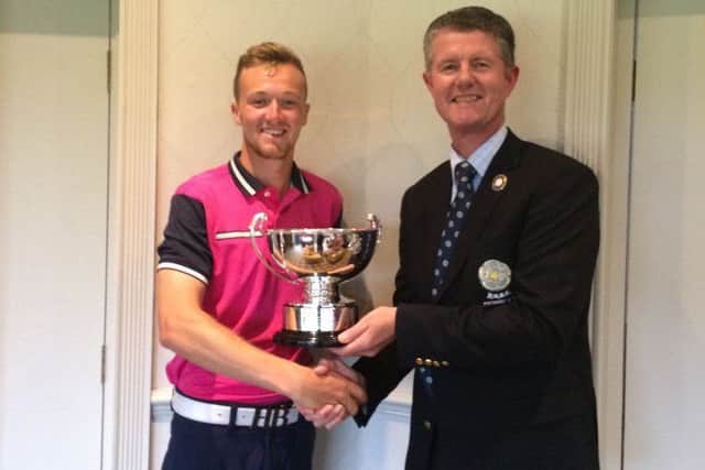 Wath's Nick Poppleton receives the Alvin Trophy, for the lowest first 36-hole score, from Yorkshire Union of Golf Clubs'president Jonathan Plaxton.