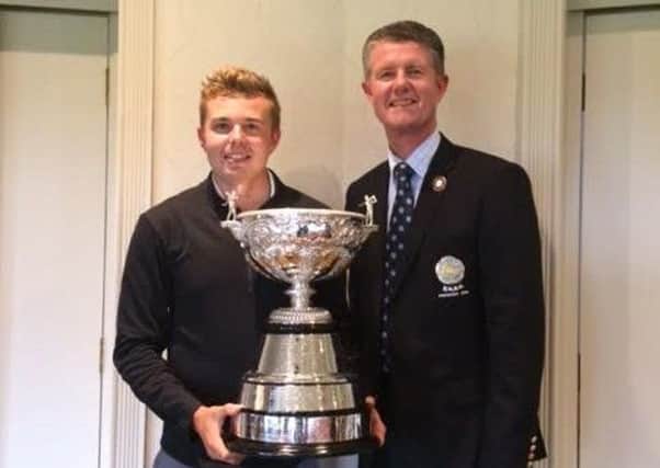New Yorkshire champion Ben Hutchinson receives the trophy from Yorkshire Union of Golf Clubs' president Jonathan Plaxton.