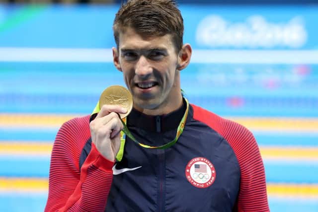 USA's Michael Phelps celebrates with his gold medal