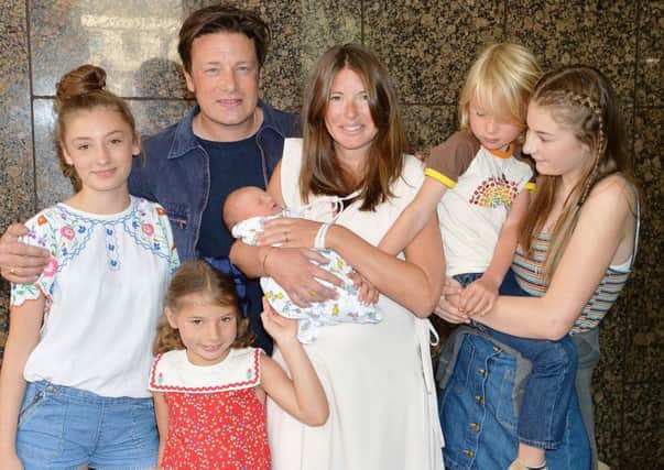 Jools and Jamie Oliver leave the Portland Hospital in central London with the newest addition to the Oliver family, a baby boy who has yet to be named, and their older children (left to right) Daisy Boo Pamela, Petal Blossom Rainbow, Buddy Bear Maurice and Poppy Honey Rosie. PRESS ASSOCIATION Photo. Picture date: Monday August 8, 2016. The couple have become parents to their fifth child - a boy who the TV chef told fans weighs the same as "16 packs of butter". See PA story SHOWBIZ Oliver. Photo credit should read: John Stillwell/PA Wire