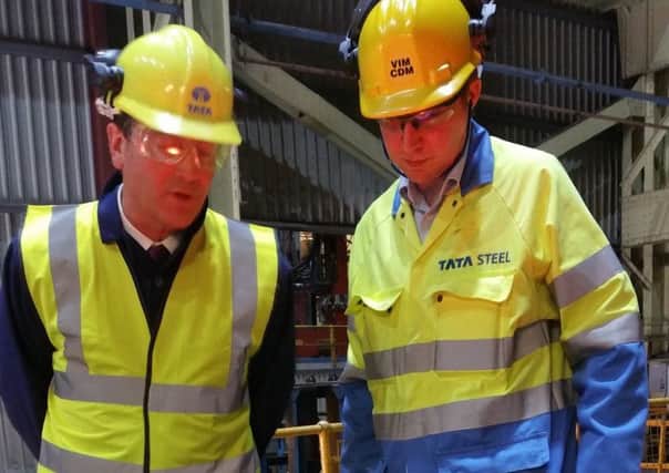 Industry minister Nick Hurd, left, is shown a VAR remelting furnace at Tata Steels in Stocksbridge