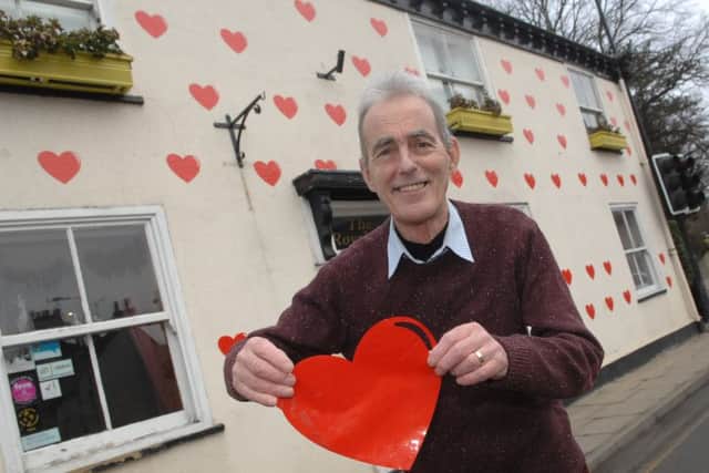 Tony Handley  decroating his house with hearts for Valentine Day. Picture: Adrian Murray.