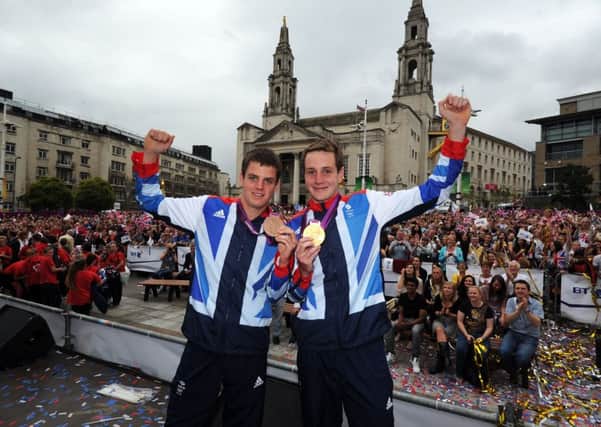 Jonny and Alistair Brownlee pictured with their Olympic medals in Millennium Square, Leeds, in 2012. Picture by Simon Hulme.