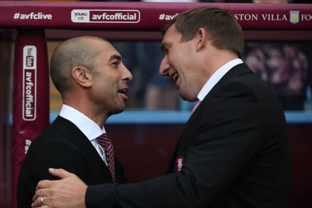 Rotherham United manager Alan Stubbs catches up with his Aston Villa counterpart Roberto Di Matteo at Villa Park on Saturday. Picture: Nick Potts/PA.