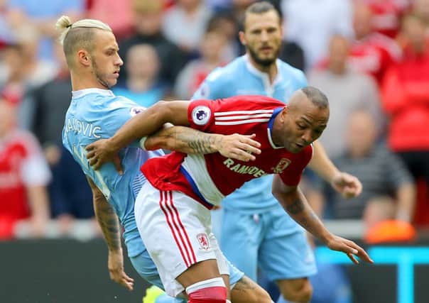 Stoke City's Marko Arnautovic (left) and Middlesbrough's   Emilio Nsue battle for the ball. Picture: Richard Sellers/PA