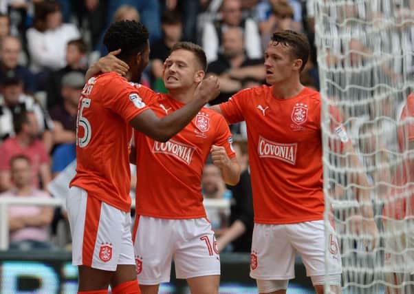 Huddersfield Town's Jack Payne (centre) celebrates with Kasey Palmer (left) and Jonathan Hogg at Newcastle.