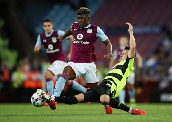 Aston Villa's Aaron Tshibola and Huddersfield Town's Jonathan Hogg (right) battle for the ball. Picture: Nick Potts/PA.