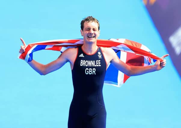 Great Britain's Alistair Brownlee celebrating as he crosses the finish line to win the Men's Triathlon on day eleven of the London Olympic Games at Hyde Park, London.