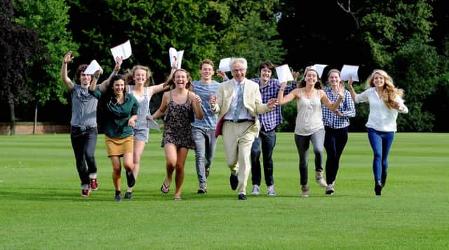 File photograph of pupils celebrating exam results at Bootham School, in York, in 2014.