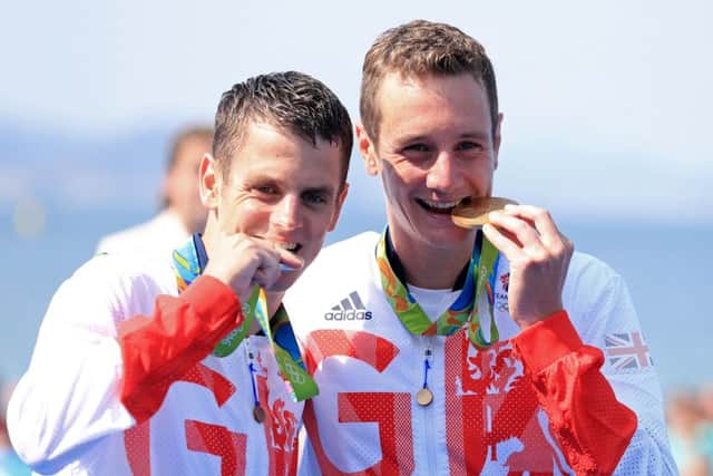 Great Britain's Alistair and Jonny Brownlee with their Gold and Silver medals for the Men's Triathlon. Picture: Mike Egerton/PA.
