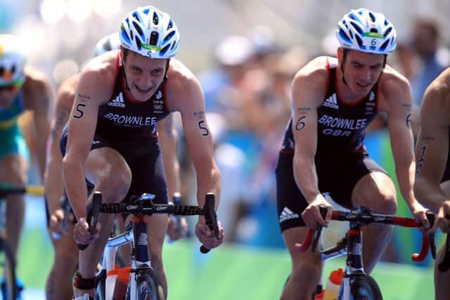 SIBLING RIVALRY: Leeds's Alistair Brownlee (left) on his bike alongside brother Jonny during the cycling section of the Men's Triathlon. Picture: Mike Egerton/PA.