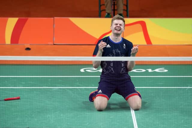Huddersfield's Marcus Ellis sinks to his knees to celebrate  victory over China's Chai Biao and Hong Wei during the men's doubles bronze medal match. Picture: Owen Humphreys/PA