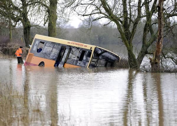 School bus stuck in flood water between Newton-on-Ouse and Tollerton, North Yorkshire, as the driver has denied dangerous driving in connection with the incident which saw 26 children having to be rescued. Picture: John Giles/PA Wire