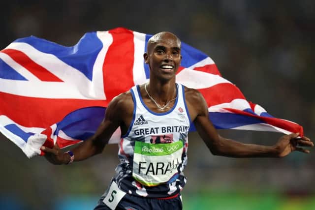 Great Britain's Mo Farah celebrates winning the men's 5000m final