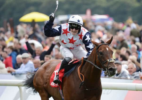 Jockey Adam McNamara celebrates as he rides Heartbreak City to victory in the Ebor at York.  (Picture: Anna Gowthorpe/PA)