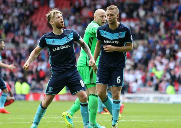 Middlesbrough's Adam Clayton (left) celebrates in front of supporters after the game during the Premier League match at the Stadium of Light, Sunderland.