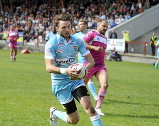 Huddersfield's Ryan Brierley runs in one of his three tries against Batley. Picture: Steve Riding.