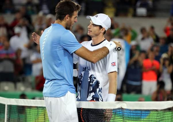 Great Britain's Andy Murray consoles Argentina's Juan MartÃ­n del Potro following victory in the men's singles final at the Olympic Tennis Centre .