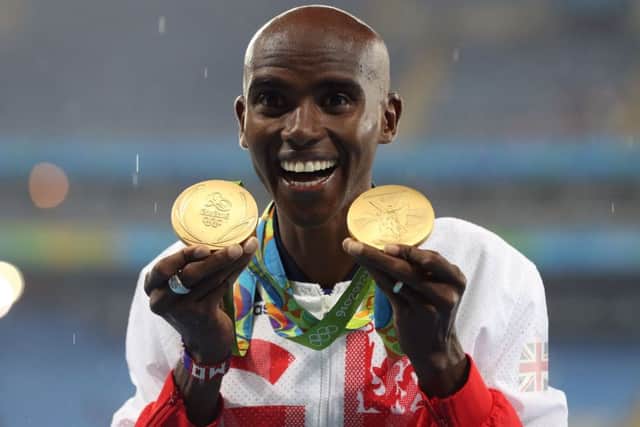 Great Britain's Mo Farah with his gold medals for victory in the Men's 5000m and 10000m. (Picture: PA)