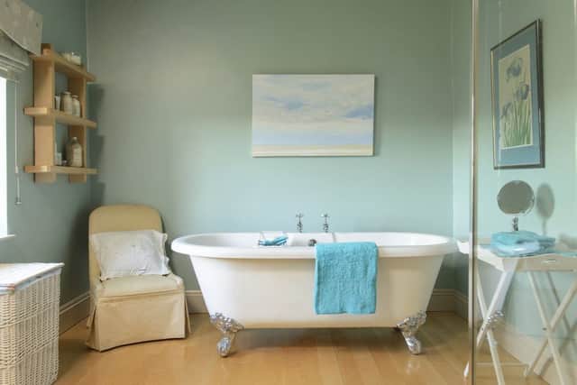 The family bathroom was tired and dated, so Penny and David had it refitted with a free-standing bath and decorated in a fresh Fired Earth blue.