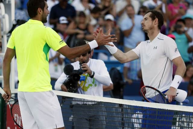 Marin Cilic, left, shakes hands with Andy Murray after beating the British No 1 in the final of the Western & Southern Open. Picture: AP/John Minchillo