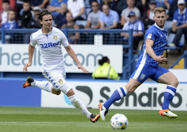 Sheffield Wednesday's Tom Lees, right, and Leeds United's Marcus Antonsson chase a loose ball during Saturday's derby (Picture: Bruce Rollinson).