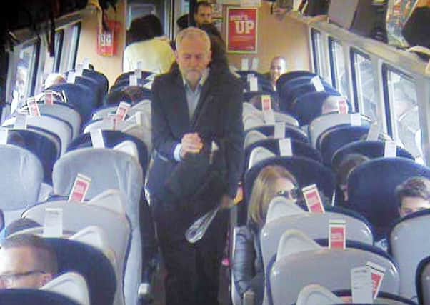 Handout  CCTV footage dated 11/08/16 issued by Virgin Trains which was filmed at 11.08am, approximately 8 min after departure from King's Cross in central London, showing Labour Party leaderJeremy Corbyn, walking past several empty, unreserved seats in Coach F, after a video emerged last week which showed Mr Corbyn sitting on the floor, reading a newspaper, and saying "This is a problem that many passengers face every day" before calling for public ownership of the railways.  Picture: Virgin Trains/PA Wire