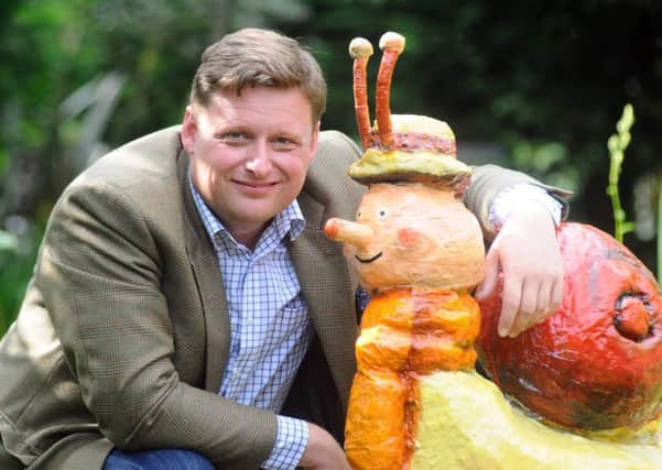 Harrogate Flower Show Director Nick Smith meets one of the colourful characters made by Horticap students for the Friend or Foe? show garden they are building at the Harrogate Autumn Flower Show.