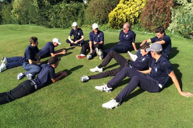 Yorkshire Boys' team manager Phil Woodcock, in sunglasses, holds a debriefing after the win over Wiltshire.