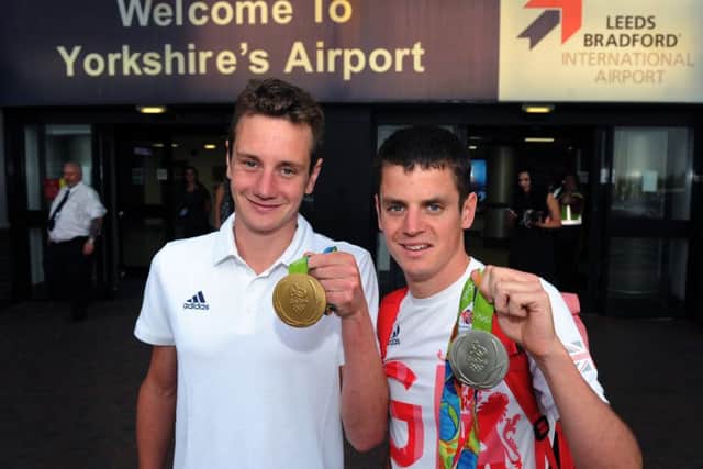 Great Britain's Alistair and Jonny Brownlee pose with their medals after arriving at Leeds Bradford International Airport.

 Picture : Jonathan Gawthorpe