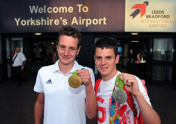 Great Britain's Alistair and Jonny Brownlee pose with their medals after arriving at Leeds Bradford International Airport.

 Picture : Jonathan Gawthorpe