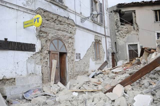 A post office is engulfed by rubble in Arcuata del Tronto, central Italy, where a 6.1 earthquake struck just after 3.30 am this morning. (AP Photo/Sandro Perozzi)