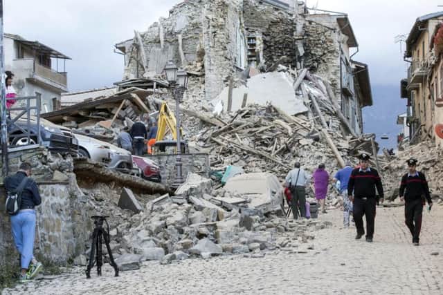 Collapsed buildings are seen following an earthquake in Amatrice.