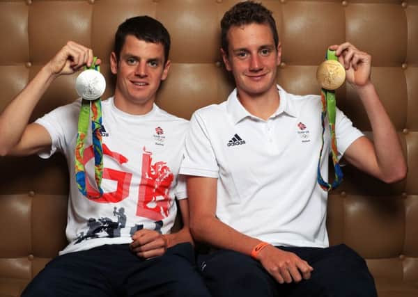 Triathletes Jonny and Alistair Brownlee return to Britain. from the Olympics.
