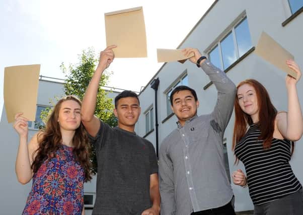 Students celebrate after receiving their GCSE results