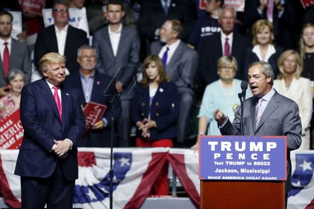 Nigel Farage, ex-leader of UKIP, speaks as Republican presidential candidate Donald Trump, left, listens, at Trump's campaign rally in Jackson, Missouri. Picture: AP Photo/Gerald Herbert.