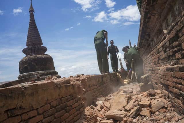 Military personnel clear debris at a temple that was damaged by a strong earthquake in Bagan, Myanmar. Picture: AP Photo/Hkun Lat.