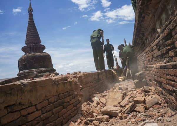 Military personnel clear debris at a temple that was damaged by a strong earthquake in Bagan, Myanmar. Picture: AP Photo/Hkun Lat.