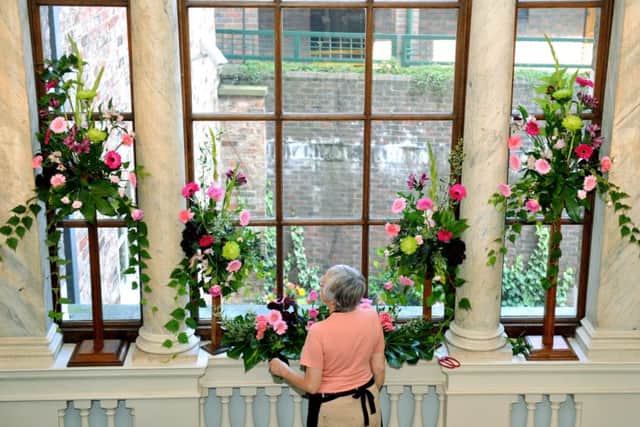 Marion Croft  from  New Earswick Flower Club getting the main staircase  at Fairfax House in York ready for this year's flower festival.