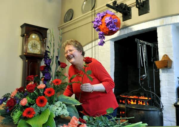 Ann Simpson from  New Earswick Flower Club getting the  Georgian kitchen at Fairfax House in York ready for this  year's flower festival.