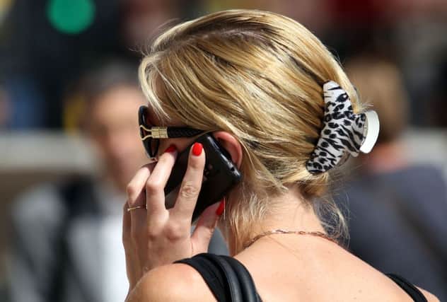 A file photo of a woman using her mobile phone     Photo:  Steve Parsons/PA Wire