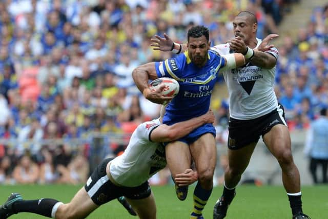 Warrington Wolves' Ryan Atkins is tackled by Hull FC's Chris Green (left) and Sika Manu during the Challenge Cup Final (PA)