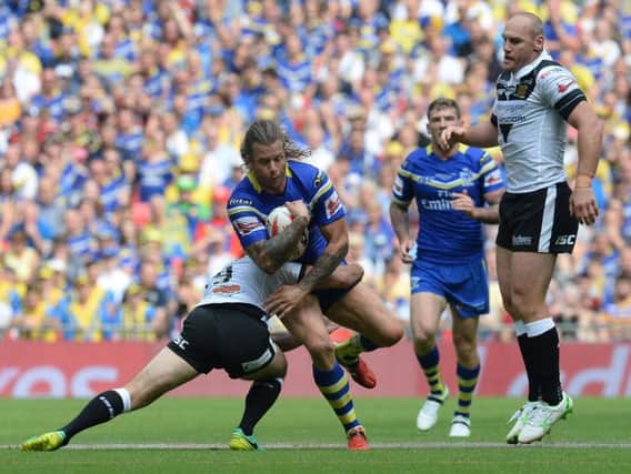 Warrington Wolves' Ashton Sims is tackled by Hull FC's Danny Houghton during the Challenge Cup Final