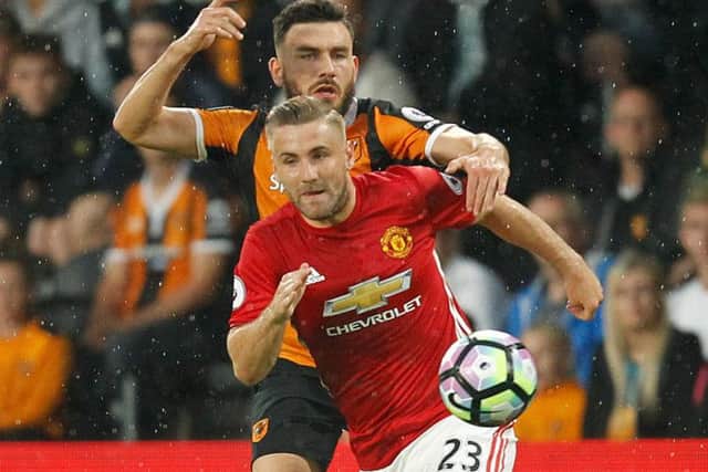 Hull City's Robert Snodgrass (left) and Manchester United's Luke Shaw battle for the ball (PA)