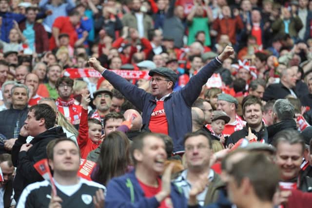 GRAND DAY OUT: Barnsley fans celebrate winning the Football League Trophy at Wembley last year. Picture by Tony Johnson